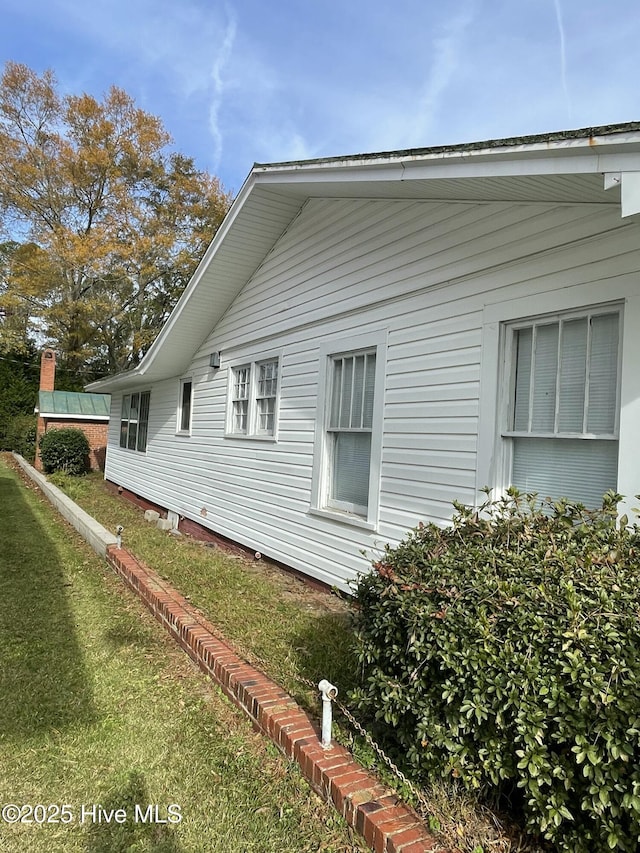 view of home's exterior with a yard