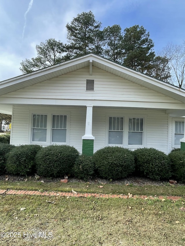 view of property exterior featuring covered porch