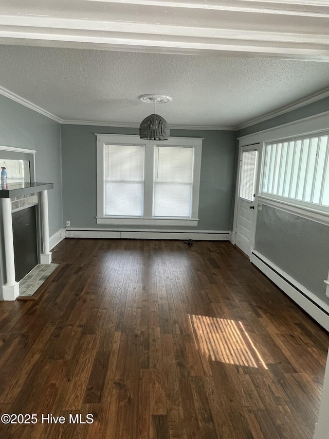 unfurnished living room featuring dark wood finished floors, a textured ceiling, crown molding, and a wealth of natural light