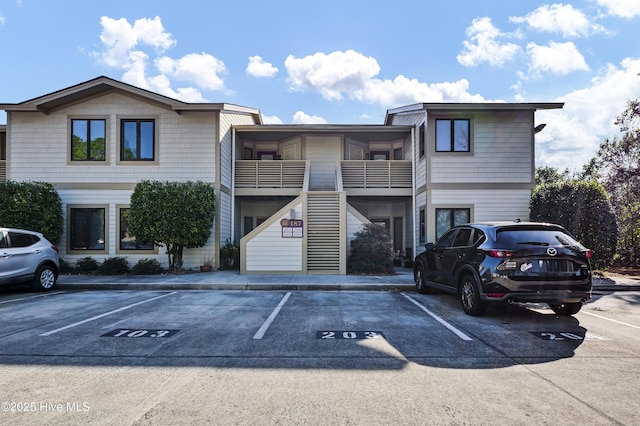 view of building exterior with uncovered parking