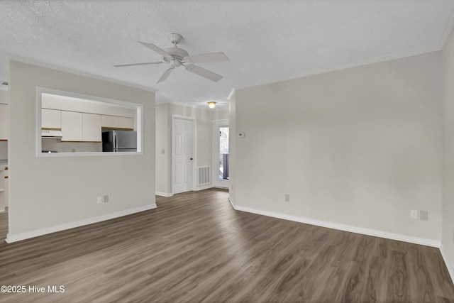 unfurnished living room with dark wood finished floors, a textured ceiling, baseboards, and ceiling fan