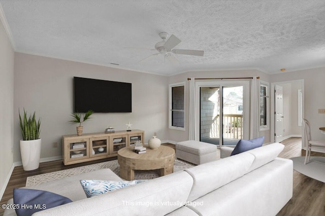 living room with baseboards, a textured ceiling, ceiling fan, and wood finished floors