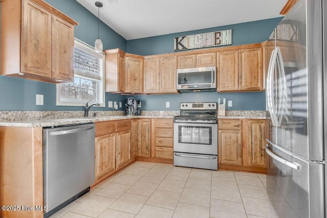 kitchen with pendant lighting, light stone counters, a sink, stainless steel appliances, and light tile patterned floors