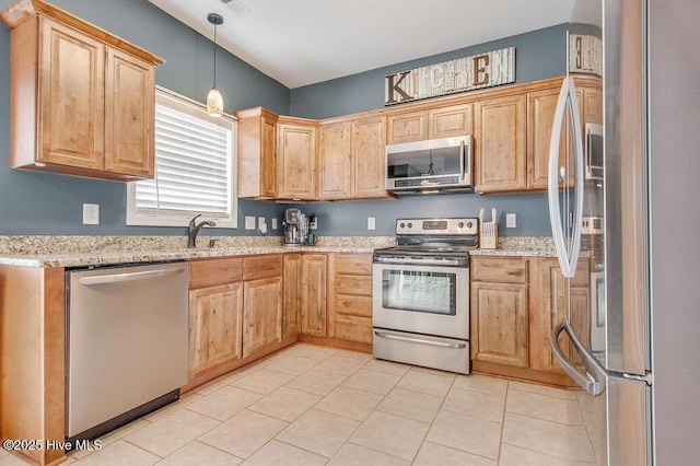 kitchen with light stone countertops, pendant lighting, light tile patterned flooring, stainless steel appliances, and a sink