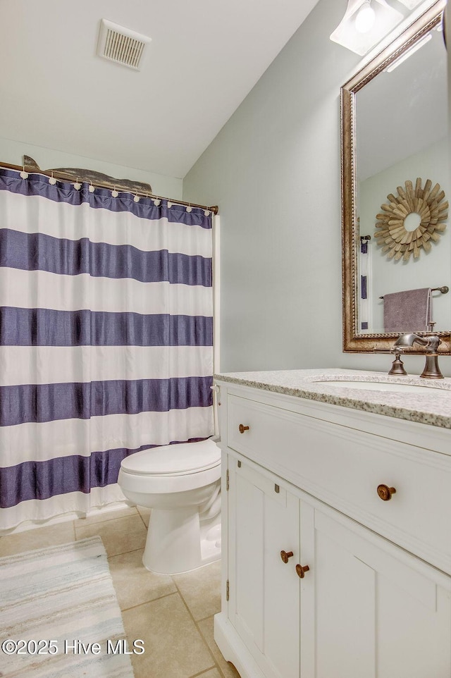 bathroom with visible vents, toilet, tile patterned flooring, lofted ceiling, and vanity