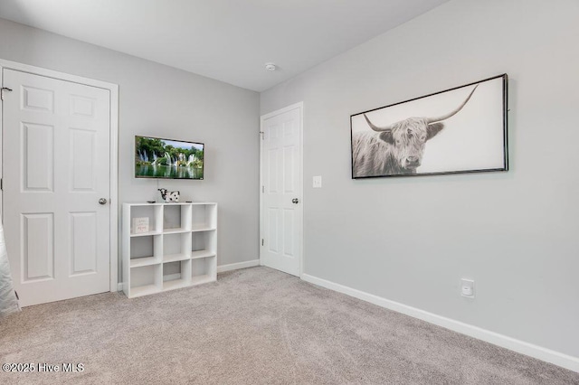 unfurnished bedroom with carpet and baseboards