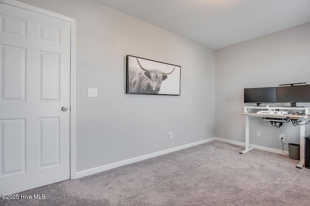 unfurnished office featuring baseboards and carpet