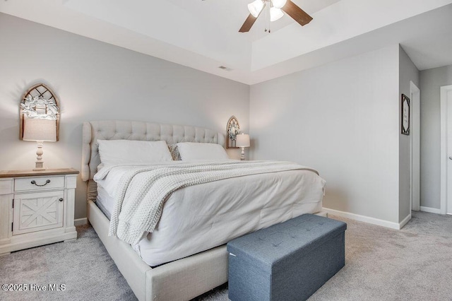 bedroom featuring visible vents, light colored carpet, baseboards, and ceiling fan