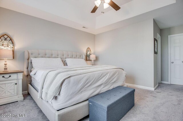 bedroom featuring a ceiling fan, baseboards, visible vents, and light carpet