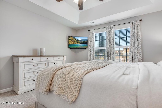 bedroom featuring light carpet, visible vents, a ceiling fan, and baseboards