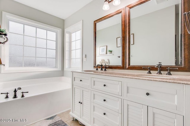 bathroom featuring double vanity, a bath, and a sink