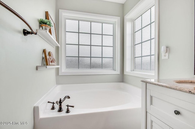 bathroom featuring vanity and a garden tub