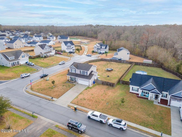 aerial view featuring a forest view and a residential view