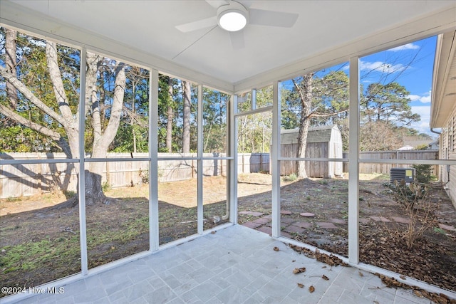 unfurnished sunroom featuring plenty of natural light and a ceiling fan