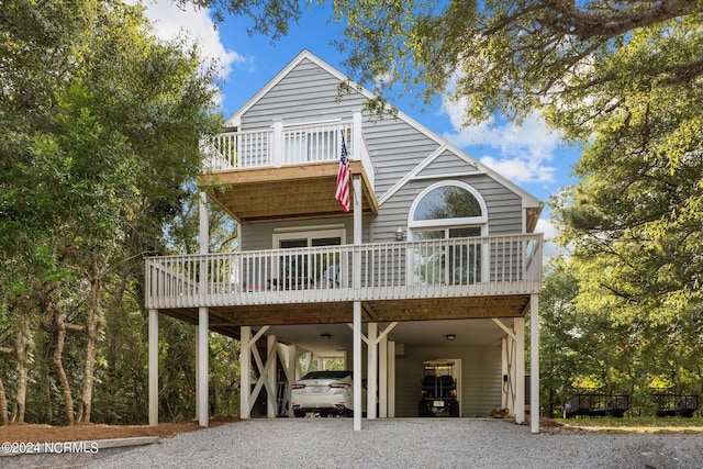 coastal inspired home with a carport and gravel driveway