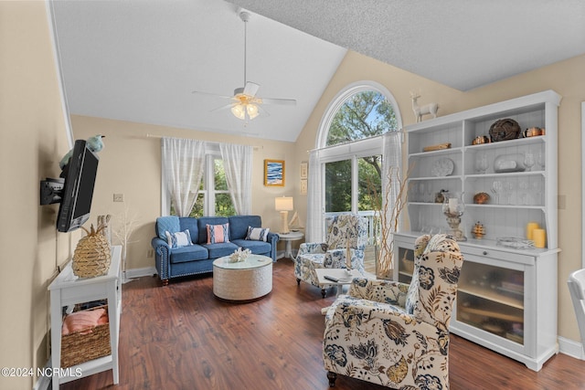 living area with vaulted ceiling, wood finished floors, baseboards, and ceiling fan