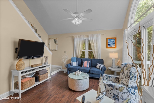 living area featuring baseboards, lofted ceiling, wood finished floors, and a ceiling fan