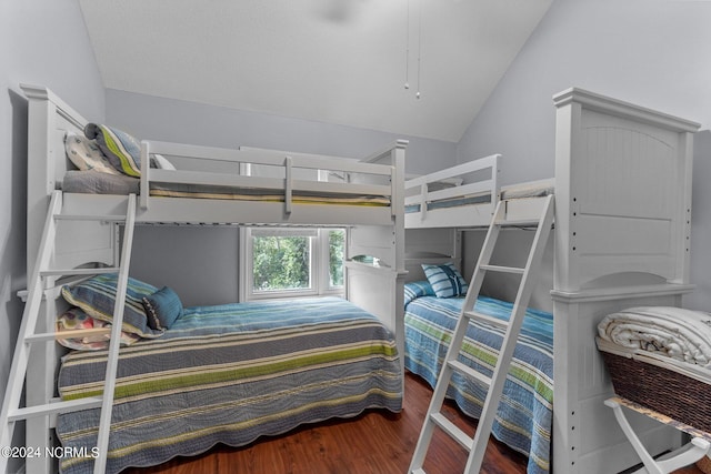 bedroom with vaulted ceiling and wood finished floors