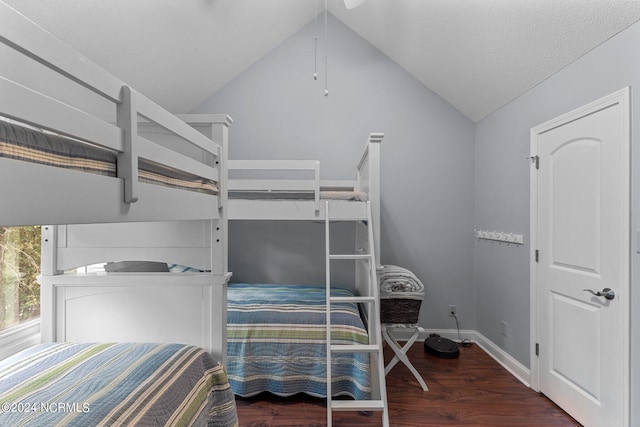 bedroom with baseboards, wood finished floors, and vaulted ceiling