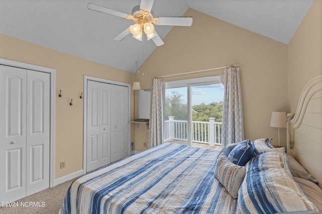 carpeted bedroom with vaulted ceiling, two closets, and access to outside