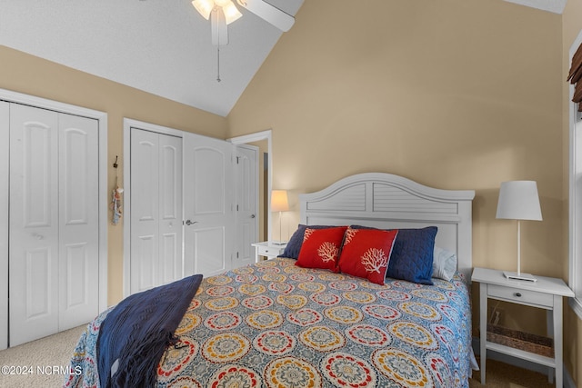 bedroom with high vaulted ceiling, a ceiling fan, two closets, and carpet floors