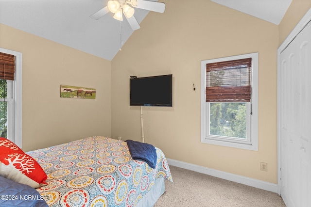 carpeted bedroom with baseboards, lofted ceiling, and a ceiling fan