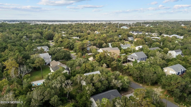 bird's eye view with a wooded view