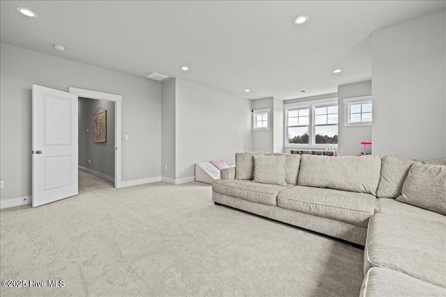 living area with recessed lighting, visible vents, baseboards, and light colored carpet