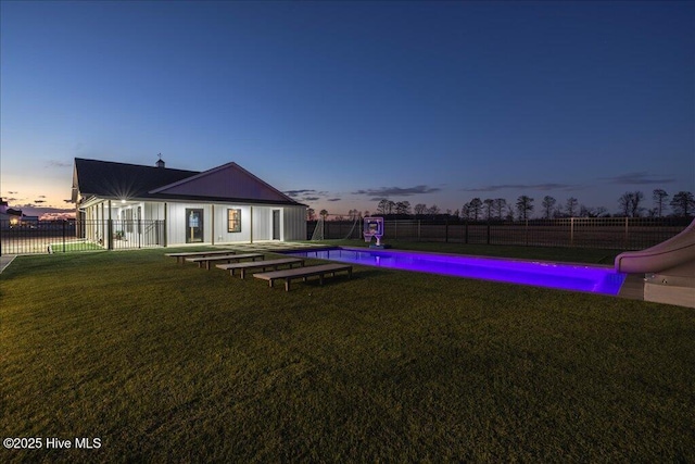 exterior space featuring a fenced in pool, a lawn, and a fenced backyard