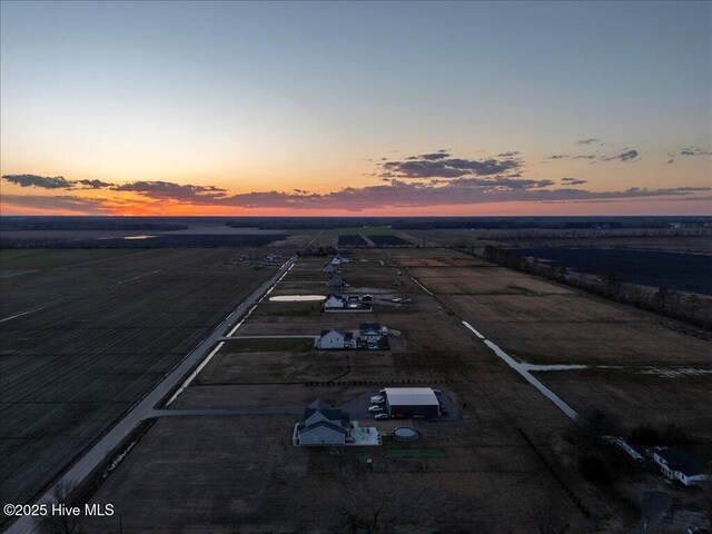 aerial view at dusk featuring a rural view