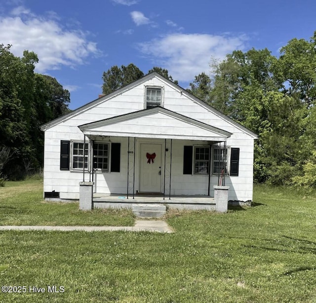 bungalow-style house with covered porch and a front yard