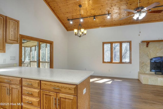 kitchen with dark wood-style floors, high vaulted ceiling, a peninsula, light countertops, and wood ceiling