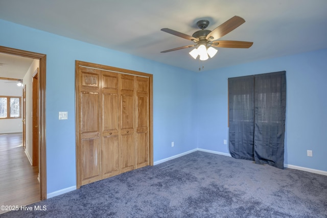 unfurnished bedroom with carpet, a ceiling fan, baseboards, and a closet