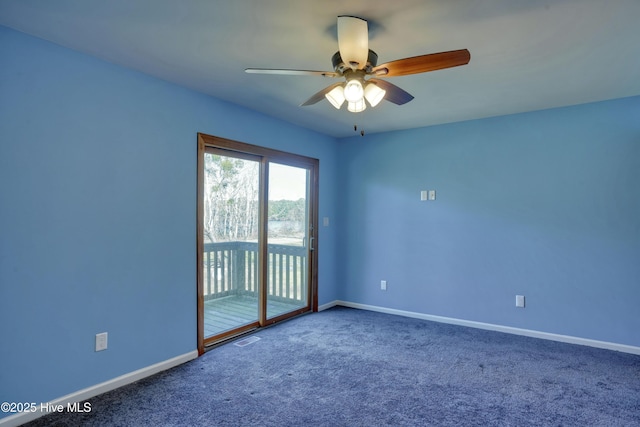 spare room with visible vents, baseboards, a ceiling fan, and carpet flooring