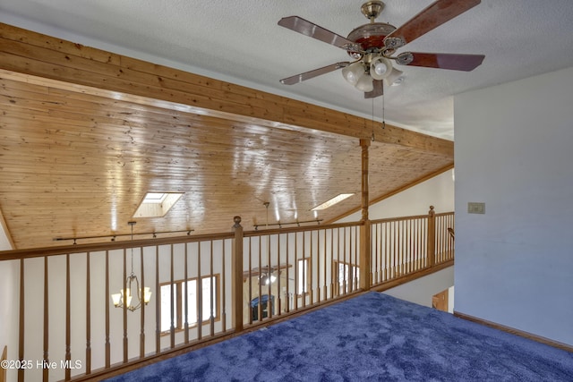 additional living space featuring ceiling fan, a textured ceiling, a skylight, and carpet flooring