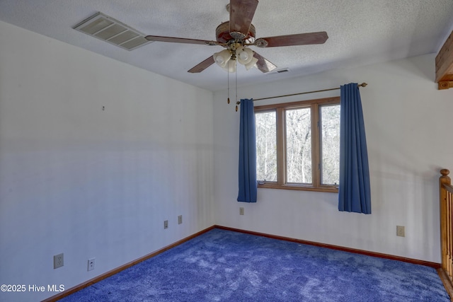 empty room featuring visible vents, baseboards, carpet, a textured ceiling, and a ceiling fan