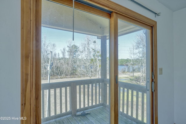 doorway to outside with a water view