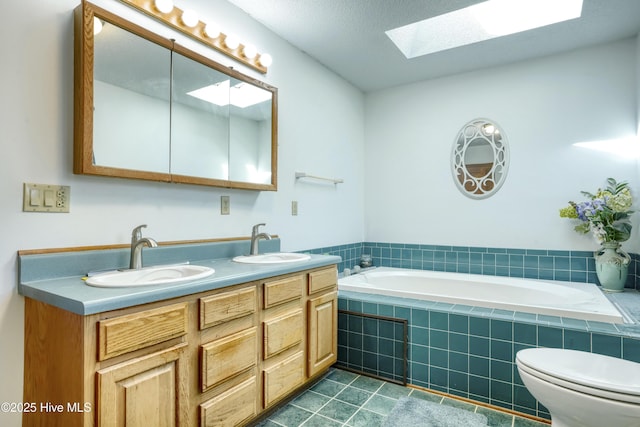 full bathroom with a bath, tile patterned flooring, a skylight, and a sink