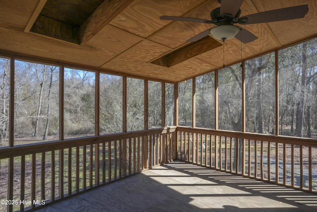 unfurnished sunroom with a ceiling fan