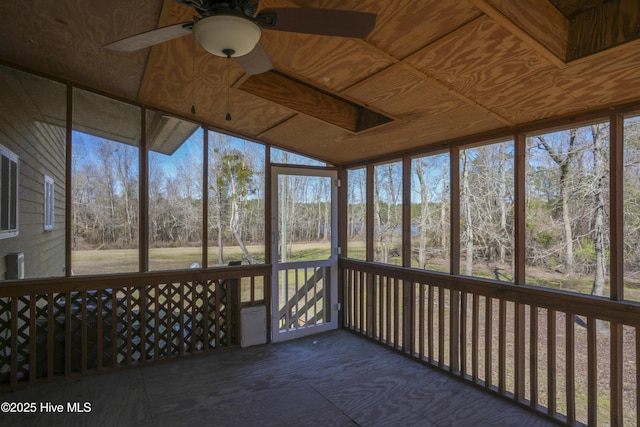 unfurnished sunroom featuring wood ceiling and a ceiling fan