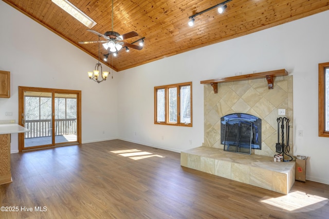 unfurnished living room featuring track lighting, wooden ceiling, high vaulted ceiling, and wood finished floors