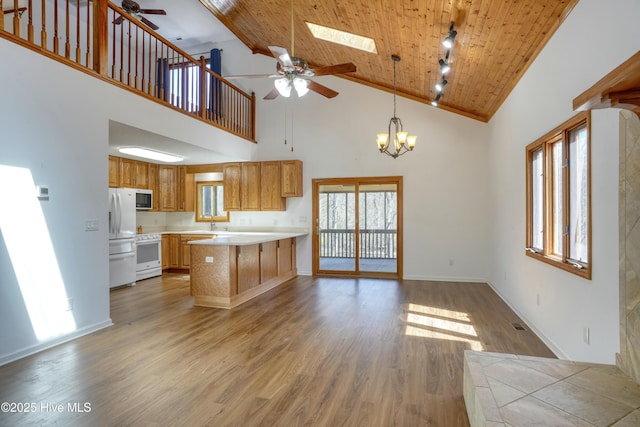 kitchen featuring ceiling fan with notable chandelier, wood finished floors, white appliances, light countertops, and wood ceiling