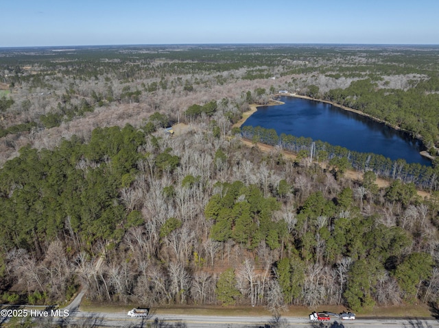 aerial view with a wooded view and a water view