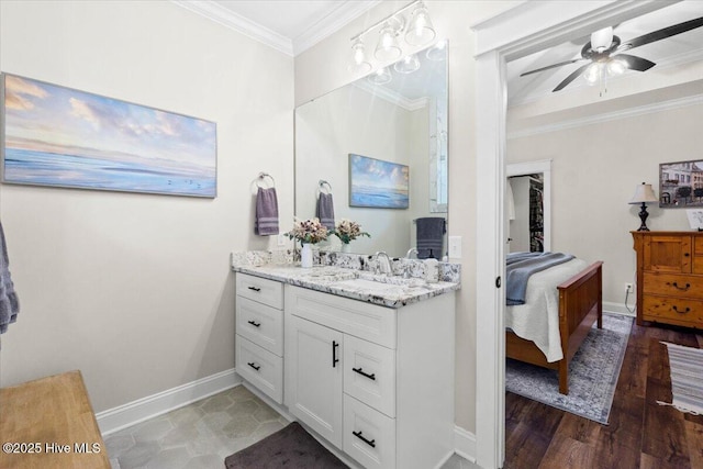 ensuite bathroom featuring ceiling fan, baseboards, ensuite bath, and crown molding