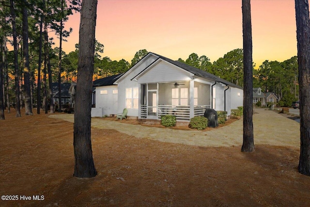 view of front facade featuring a ceiling fan and a sunroom