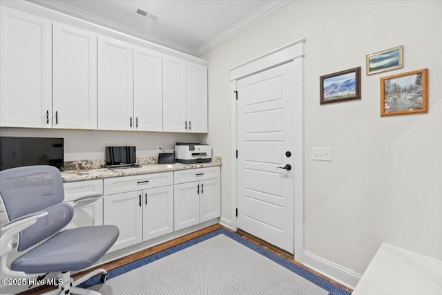 office with visible vents, light wood-style flooring, crown molding, and baseboards