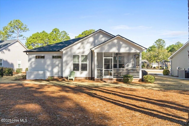 back of property with central air condition unit, a ceiling fan, and a sunroom