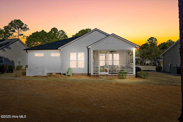 back of house featuring a porch, a yard, and ceiling fan