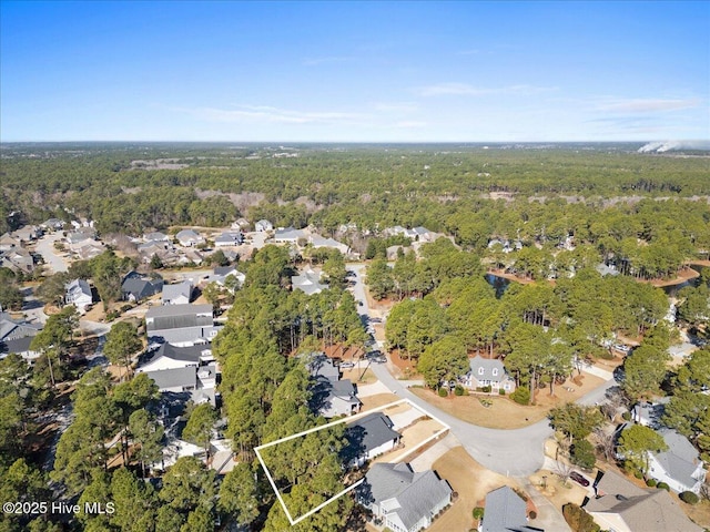 aerial view with a residential view and a view of trees