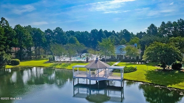 dock area with a yard and a water view